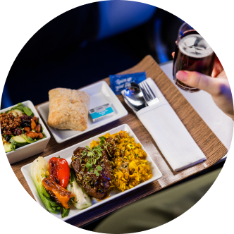 Inflight meal on wooden tray with real silverware