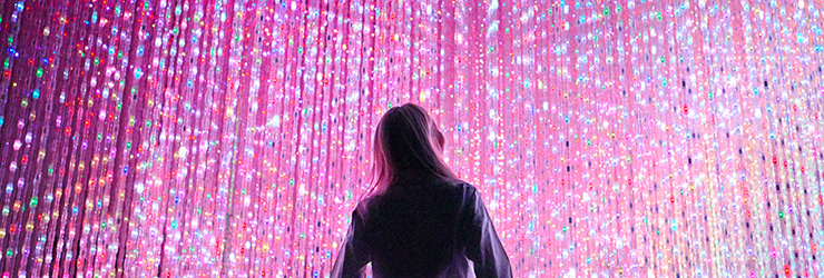 A person looking at a wall filled with lights.